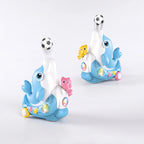 A blue dolphin-shaped musical toy that blows air to float a small soccer ball